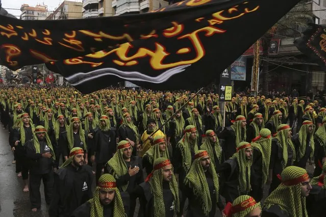 Lebanese Hezbollah supporters march during a religious procession to mark Ashoura in Beirut's suburbs November 4, 2014. (Photo by Aziz Taher/Reuters)