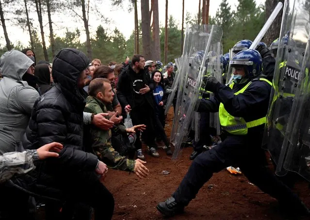 Revellers clash with riot police at the scene of a suspected illegal rave in Thetford Forest, in Norfolk, Britain, August 30, 2020. (Photo by Toby Melville/Reuters)