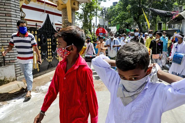Muslims wearing face masks beat drums as they take part in a Muharram procession in Kolkata, India, Sunday, August 30, 2020. India has the third-highest coronavirus caseload after the United States and Brazil, and the fourth-highest death toll in the world. (Photo by Bikas Das/AP Photo)