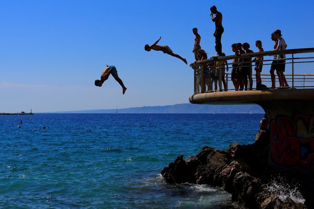 Young people dive in the Mediterranean Sea on a sunny and warm summer day in Marseille as an early summer heatwave hits France on July 1, 2025. (Photo by Manon Cruz/Reuters)