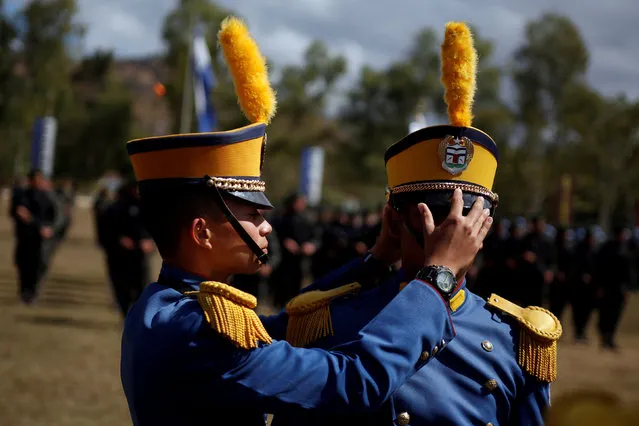 A military cadet adjusts the hat of a colleague during a promotion ceremony for the members of the Honduran armed forces in Tegucigalpa, Honduras February 16, 2018. (Photo by Jorge Cabrera/Reuters)