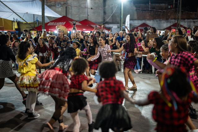 Children dance hand in hand during a celebration of harvest in the Manguinhos community in Rio de Janeiro, Brazil, July 19, 2025. (Photo by Xinhua News Agency/Rex Features/Shutterstock)