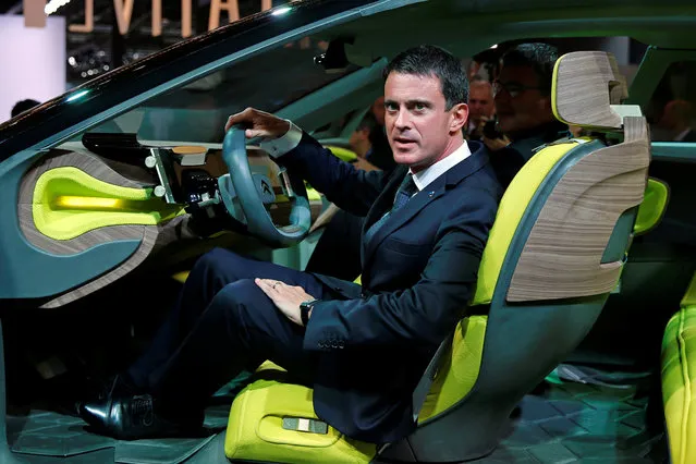French Prime Minister Manuel Valls seats in the Citroen CXperience as he tours the stand for French car manufacturer Citroen on media day at the Paris auto show, in Paris, France, September 30, 2016. (Photo by Benoit Tessier/Reuters)