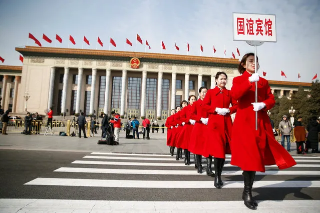 Ushers walk outside the Great Hall of the People during the opening session of the National People's Congress (NPC) in Beijing, China on March 5, 2018. (Photo by Thomas Peter/Reuters)