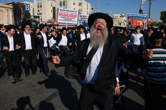 Ultra-Orthodox Jewish demonstrators chant to protest their conscription in Israel's military and the arrest of religious school students who avoided draft orders, during a rally in Jerusalem on August 7, 2025. The conscription of ultra-Orthodox Jews is a highly contentious issue for Israeli society, large parts of which are required to serve in the army. Under an arrangement since Israel's 1948 founding, ultra-Orthodox Jews have been exempted from military service as long as they dedicate themselves to religious studies. But public support for the exemptions has waned, particularly as the army faces manpower shortages after more than 21 months of war in Gaza. (Photo by Menahem Kahana/AFP Photo)