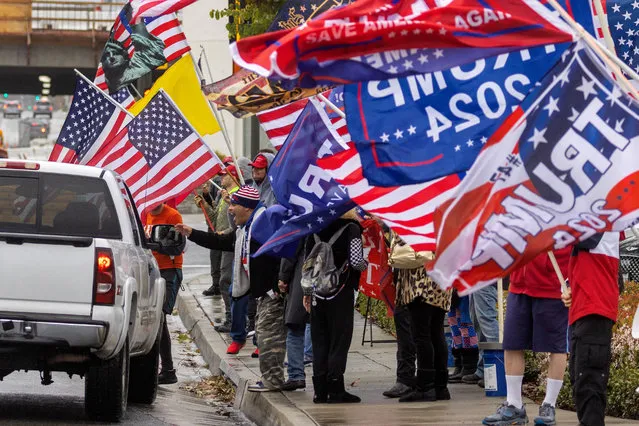 Supporters of former U.S. President Donald Trump gather for a loyalty rally at a busy intersection in Laguna Hills, California, U.S., March 21, 2023. (Photo by Mike Blake/Reuters)