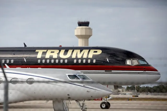 A plane of former U.S. President Donald Trump is seen parked at the Palm Beach International Airport after he posted a message on his Truth Social account saying that he expects to be arrested on Tuesday, and called on his supporters to protest, in West Palm Beach, Florida, U.S. March 20, 2023. (Photo by Marco Bello/Reuters)