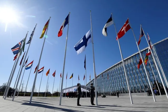 Finnish military personnel install the Finnish national flag at the NATO headquarters in Brussels, on April 4, 2023. - Finland on April 4, 2023 became the 31st member of NATO, wrapping up its historic strategic shift with the deposit of its accession documents to the alliance. (Photo by John Thys/AFP Photo)