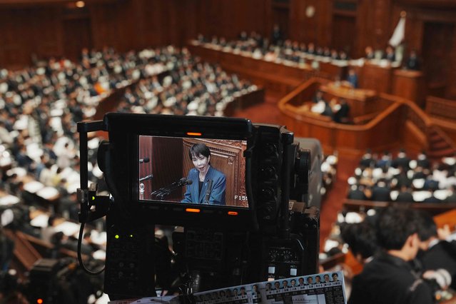 A television camera broadcasts Japan's Prime Minister Sanae Takaichi's speech at the House of Representatives plenary session in Tokyo on October 24, 2025. Japan's new prime minister Sanae Takaichi said on October 24 she would try to achieve the country's target of spending two percent of GDP on defence two years early. (Photo by Kazuhiro Nogi/AFP Photo)