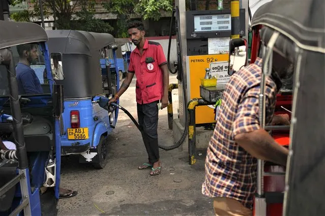A man fills gas into a vehicle at a fuel station in Colombo, Sri Lanka, Wednesday, March 29, 2023. Sri Lanka’s government has announced reduction in fuel prices, the first significant relief to the public after a year of shortages and skyrocketing prices amid the country’s worst economic crisis. (Photo by Eranga Jayawardena/AP Photo)
