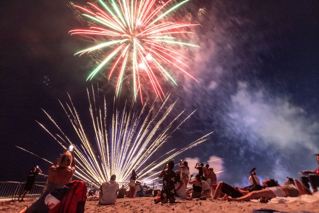 People watch fireworks during Independence Day celebrations in Miami Beach, Florida, USA, 04 July 2024. Independence Day (Fourth of July) has been a federal holiday in the United States since 1941. Still, the tradition of Independence Day celebrations dates back to the 18th century and the American Revolution. (Photo by Cristobal Herrera-Ulashkevich/EPA)
