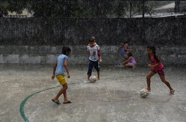 Children play soccer on an asphalt pitch in Payatas, Quezon City, Metro Manila, Philippines, May 9, 2018. (Photo by Dondi Tawatao/Reuters)
