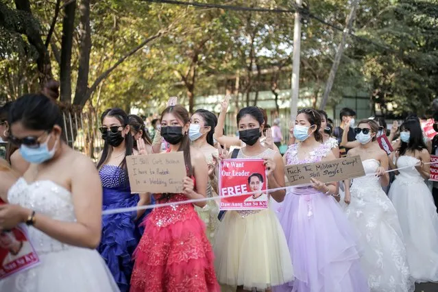 Women wearing ball gowns protest against the military coup and to demand the release of elected leader Aung San Suu Kyi in Yangon, Myanmar on February 10, 2021. (Photo by Kyaw Soe Thet via Reuters)
