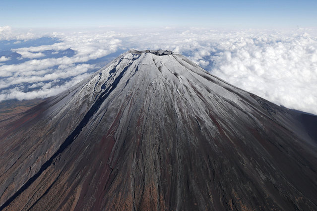 The first snowfall near the summit of Mount Fuji is observed above Yamanashi and Shizuoka Prefectures on November 7, 2024. The Kofu Regional Meteorological Observatory announced on November 7 that it had observed the first snowfall on Mount Fuji. This was 36 days later than the average to make the latest first snowfall in the past 130 years since statistics began being kept in 1894. (Photo by The Yomiuri Shimbun via AP Images)