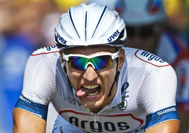 Stage winner Marcel Kittel of Germany grimaces after crossing the finish line of the twelfth stage of the Tour de France cycling race over 136.2 miles which started in Fougeres and finishes in Tours, western France, on July 11, 2013. (Photo by Laurent Rebours/Associated Press)