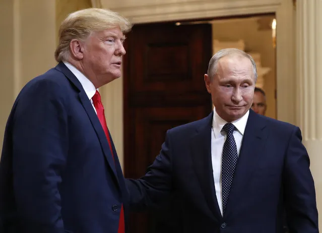 U.S. President Donald Trump, left, and Russian President Vladimir Putin leave a press conference after their meeting at the Presidential Palace in Helsinki, Finland, Monday, July 16, 2018. (Photo by Pablo Martinez Monsivais/AP Photo)