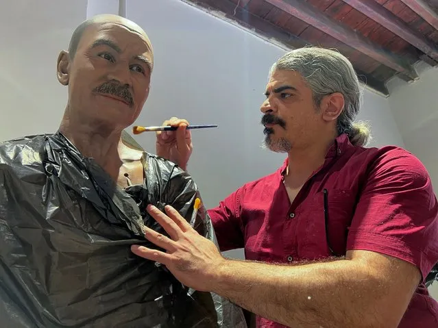 An artist works on semi-assembled wax figures to be displayed in a new museum in Basra, Iraq on June 12, 2023. (Photo by Mohammed Aty/Reuters)