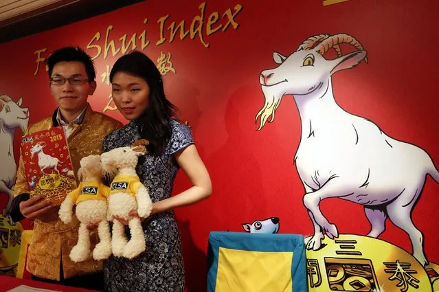 “Wand bearer” Marco Yau (L) and “Wicked witch of the East” Cherry Ma, both associated analysts from CLSA, pose with toy goats and a 2015 Feng Shui Index, during a news conference in Hong Kong February 5, 2015. Asian brokerage CLSA published on Wednesday its Feng Shui Index, a tongue-in-cheek forecast for the Hang Seng and sector outlooks for Hong Kong and China. (Photo by Bobby Yip/Reuters)