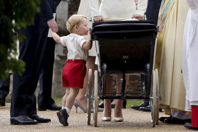 Britain's Prince George looks into the pram of his sister Princess Charlotte after her christening at the Church of St. Mary Magdalene in Sandringham, Britain July 5, 2015. (Photo by Matt Dunham/Reuters)