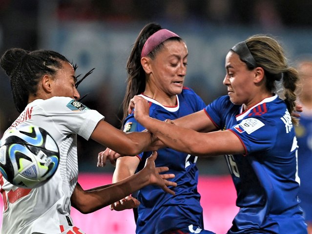 Switzerland's forward #19 Eseosa Aigbogun (L) fights for the ball with Philippines' defender #16 Sofia Harrison (R) and Philippines' forward #21 Katrina Guillou during the Australia and New Zealand 2023 Women's World Cup Group A football match between the Philippines and Switzerland at Dunedin Stadium in Dunedin on July 21, 2023. (Photo by Sanka Vidanagama/AFP Photo)
