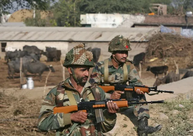 Indian army soldiers stand guard near the Indian Air Force (IAF) base at Pathankot in Punjab, India, January 3, 2016. A gold medal-winning Indian shooter was among 10 people killed in an audacious pre-dawn assault on the air force base, officials said on Sunday as troops worked to clear the compound near India's border with Pakistan after a 15-hour gunbattle. (Photo by Mukesh Gupta/Reuters)
