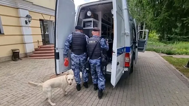 In this photo taken from video released by the National Guard Troops Federal Service of the Russian Federation on Saturday, July 22, 2023, Russian Rosguardia (National Guard) servicemen work near a house where special forces killed a gunman who refused to surrender and fired at them in an elite cottage village in the Istra region, about 45 kilometers, less than 30 miles, west of Moscow, Russia. Russia's National Guard says security forces killed a heavily-armed gunman who broke into a private house in Moscow's suburbs and fired at them, reportedly threatening to march on the Kremlin. (Photo by National Guard Troops Federal Service of the Russian Federation via AP Photo)