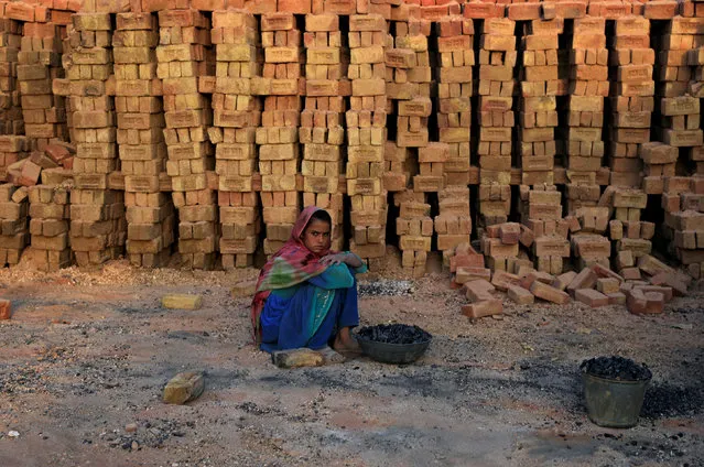 A girl takes a break while working at a brick-making factory on the outskirts of Islamabad, Pakistan October 1, 2018. (Photo by Faisal Mahmood/Reuters)