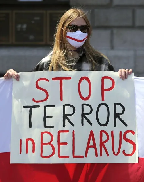 Members of the Belarusian community in Ireland, protest outside the GPO building in Dublin, Ireland, in support of political prisoners in Belarus, Saturday May 29, 2021.  The demonstration is calling for release of dissident voices in Belarus, including the recently detained journalist Roman Protasevich after his flight was forced to land. (Photo by Niall Carson/PA Wire via AP Photo)
