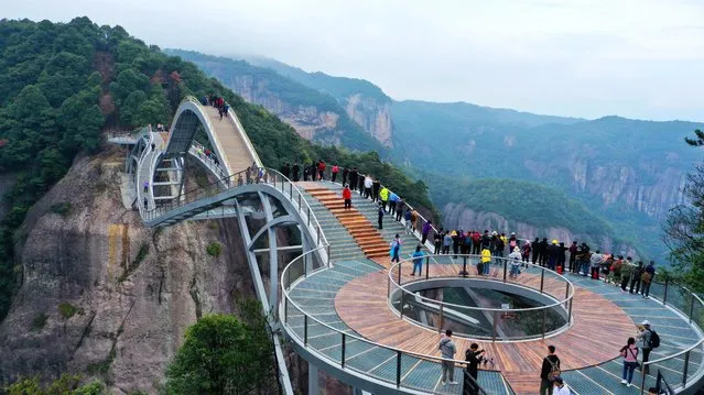 The “Ruyi Bridge” in the Shenxianju Scenic Area in Xianju county is shaped like a jade Ruyi in the sky, attracting many tourists to take pictures in Taizhou City, East China's Zhejiang Province, 17 October 2020. (Photo by Imaginechina Limited/Alamy Stock Photo)