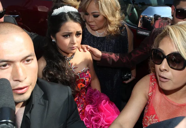 Mexican teenager Rubi (C) arrives to her 15th birthday party in La Joya, Mexico, 26 December 2016. Rubi shot to fame when her parents posted a video on social media inviting everyone who can, to attend their daughter's “coming of age” 15th year birthday party in La Joya. On Facebook more than 1.3 million people reported to attend the event, with the video getting viral and uploaded to other social media platforms numerous times, clocking up millions of views in the process, triggering jokes and even sponsorship offers for the event. (Photo by Mario Guzman/EPA)