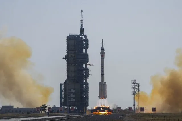 A Long March rocket carrying a crew of Chinese astronauts in a Shenzhou-17 spaceship lifts off at the Jiuquan Satellite Launch Center in northwestern China, Thursday, October 26, 2023. (Photo by Andy Wong/AP Photo)