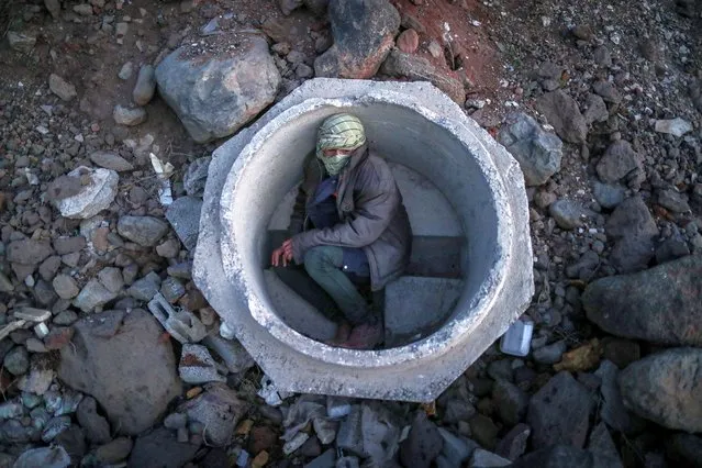 An Afghan boy hides inside a sewer pipe made of concrete next to a railway near Van city after crossing the Iran-Turkey border, 02 June 2021. Illegal immigrants and non-recognized refugees wait for days for their smugglers to transfer them to Diyarbakir city to reach West Turkey. The city of Van, on the Turkish-Iranian border, is one of the points at which human smuggling can be easily spotted. Smugglers charge between 600 or 1,000 US dollars per person, depending on the security situation at the border. (Photo by Sedat Suna/EPA/EFE)