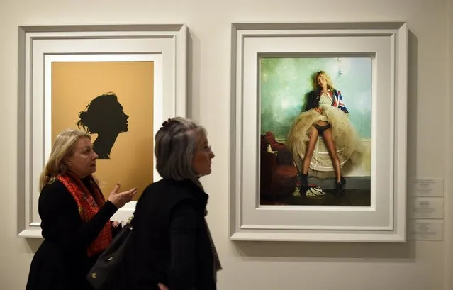 Woman walk by framed photos at the press preview for “Vogue 100: A Century of Style” exhibiting the photographs that has been commissioned by British Vogue since it was founded in 1916 at National Portrait Gallery on February 10, 2016 in London, England. (Photo by Stuart C. Wilson/Getty Images)