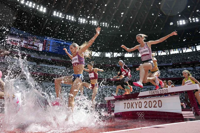 Runners compete in the heats of the women's 3,000-meters steeplechase at the 2020 Summer Olympics, Sunday, August 1, 2021, in Tokyo. (Photo by Matthias Schrader/AP Photo)