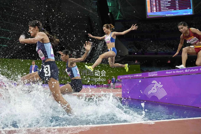 Runners compete during the women's 3000-meter steeplechase final at the 19th Asian Games in Hangzhou, China, Monday, October 2, 2023. (Photo by Lee Jin-man/AP Photo)