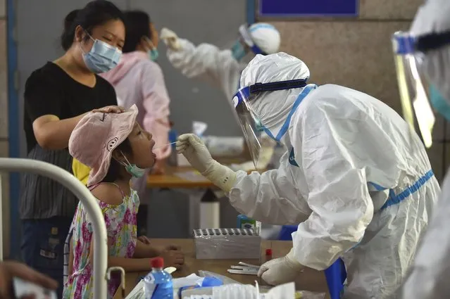 A nurse takes swab samples in the new rounds of Covid-19 testing in Nanjing in eastern China's Jiangsu province Monday, August 2, 2021. (Photo by Chinatopix via AP Photo)