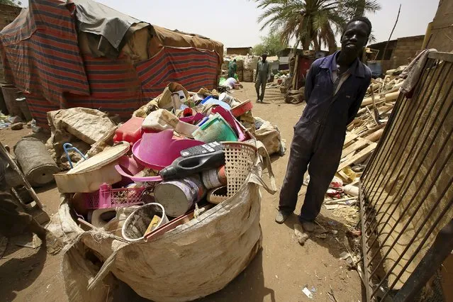 A man waits near different types of plastic materials after bringing them to a recycling station in Khartoum North April 16, 2015. (Photo by Mohamed Nureldin Abdallah/Reuters)