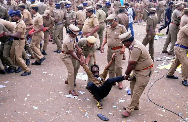 Police remove a demonstrator from Marina beach during a protest demanding a permanent solution to ensure the unhindered conduct of Jallikattu, a traditional bull-taming contest, in Chennai, India, January 23, 2017. (Photo by Reuters/Stringer)