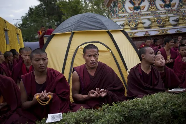 Buddhist monks from Kopan monastery offer a prayer for the people affected during Saturday's earthquake in Kathmandu, Nepal, Monday, April 27, 2015. The earthquake was the worst to hit the South Asian nation in more than 80 years. (Photo by Bernat Armangue/AP Photo)
