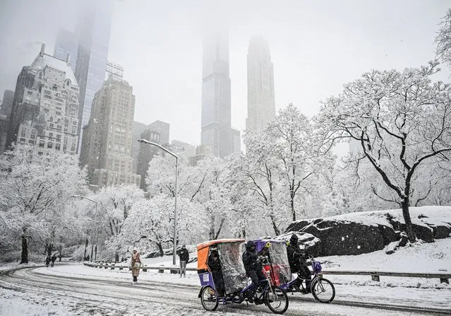 People spend time at Central Park to enjoy the weather on a snowy day in New York City, New York, United States on February 13, 2024. (Photo by Fatih Aktas/Anadolu via Getty Images)