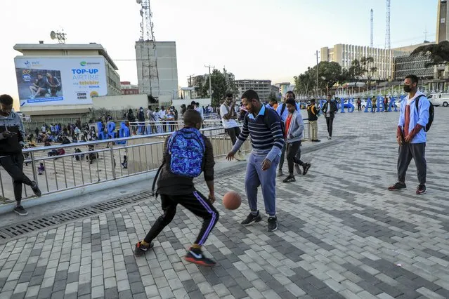 People play with a ball in the Piazza old town area of the capital Addis Ababa, Ethiopia Thursday, November 4, 2021. Urgent new efforts to calm Ethiopia's escalating war are unfolding Thursday as a U.S. special envoy visits and the president of neighboring Kenya calls for an immediate cease-fire while the country marks a year of conflict. (Photo by AP Photo/Stringer)