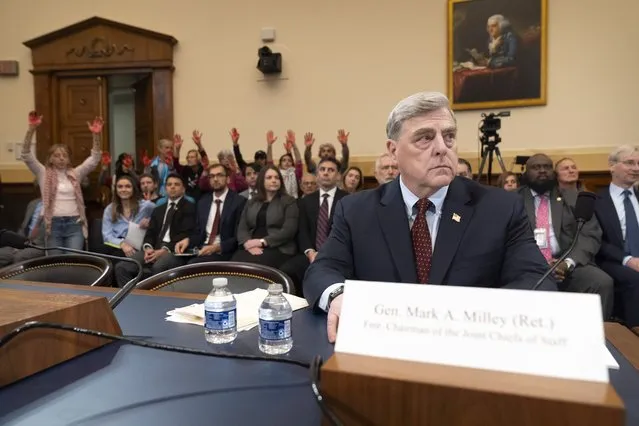 Demonstrators from Code Pink stand with red-colored hands as retired Gen. Mark Milley, the former chairman of the Joint Chiefs of Staff, waits to appear before the House Foreign Affairs Committee about the U.S. withdrawal from Afghanistan on Capitol Hill, Tuesday, March 19, 2024, in Washington. (Photo by Mark Schiefelbein/AP Photo)