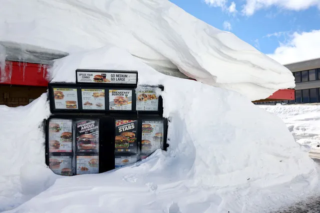 A Carl's Jr. drive-through menu is partially buried in a snowbank after a series of atmospheric river storms brought heavy snowfall to the region on January 22, 2023 in Mammoth Lakes, California. California was slammed by a barrage of atmospheric river storms which ended last week and delivered massive amounts of snowfall to the Sierra Nevada mountain's raising California’s snowpack to nearly 250 percent above average. Meltwater from California’s snowpack provides an essential source of water to the state and the widespread precipitation has led to a lower drought status as reservoirs have begun to fill. (Photo by Mario Tama/Getty Images)