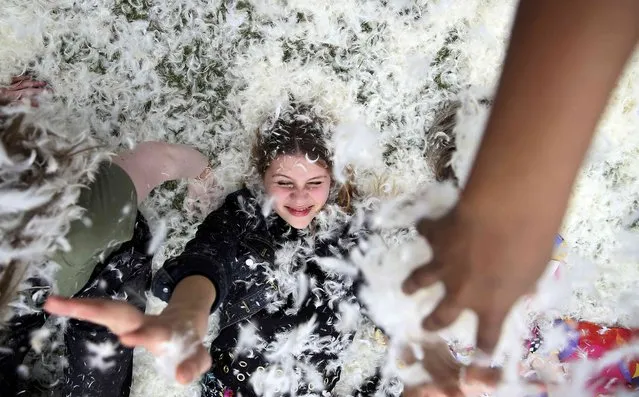 Participants take part in International Pillow Fight Day in Kennington Park in south London, Britain April 2, 2016. (Photo by Neil Hall/Reuters)