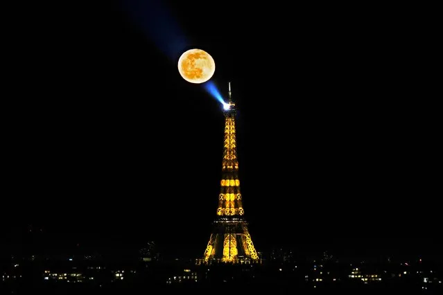 The waning gibbous moon appears in the sky following the weekend's full “Snow Moon”, near the Eiffel Tower in Paris, on February 28, 2021. (Photo by Thomas Coex/AFP Photo)