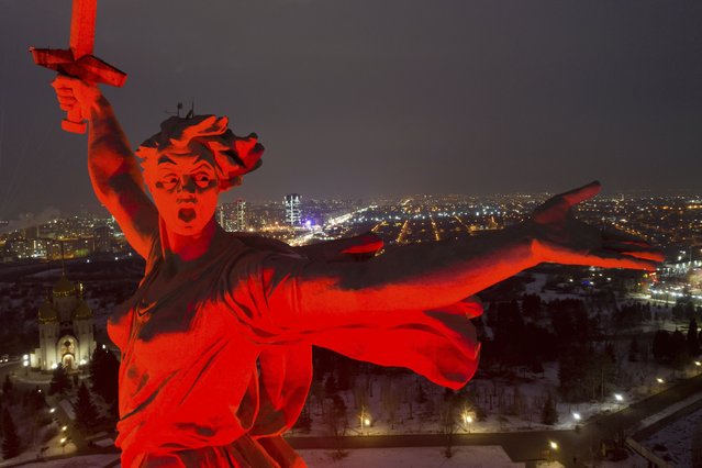 A giant statue of “Mother of the Homeland” is seen atop the memorial site on Mamayev Hill illuminated for marking the 80th anniversary of the Soviet victory in the battle of Stalingrad in the southern Russian city of Volgograd, once known as Stalingrad, Russia, Wednesday, February 1, 2023. The battle of Stalingrad turned the tide of World War II and is regarded as the bloodiest battle in history, with the death toll for soldiers and civilians estimated at about 2 million. (Photo by AP Photo/Stringer)