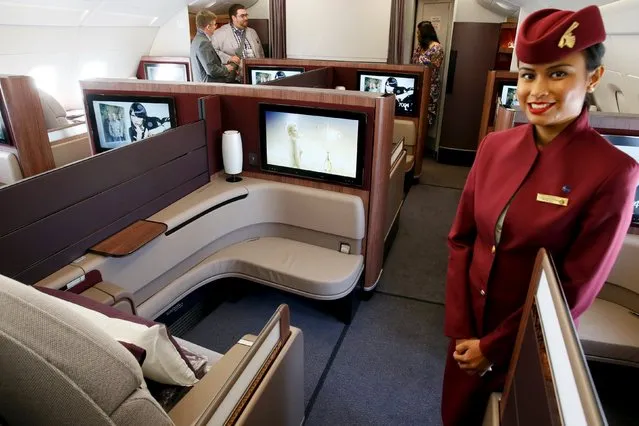A Qatar Airways crew member presents the first class seats of an Airbus A380 aircraft during the 51st Paris Air Show at Le Bourget airport near Paris June 17, 2015. REUTERS/Pascal Rossignol 