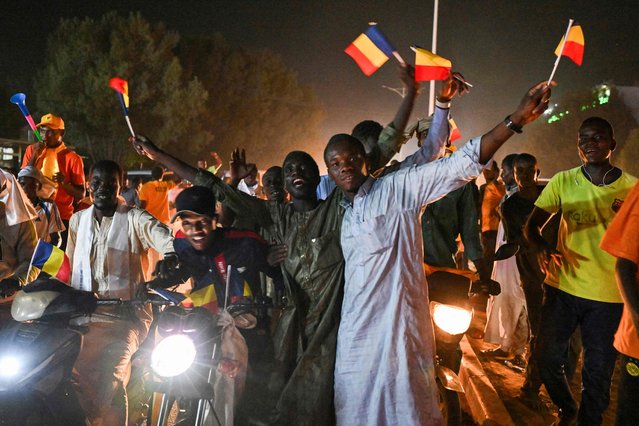 Supporters of Chad's junta chief Mahamat Idriss Deby Itno celebrate their candidate's victory in a street in N'Djamena on May 9, 2024, after the electoral commission said Deby won 61.03 percent of votes, beating his Prime Minister Succes Masra who only garnered 18.53 percent. Soldiers fired shots in the air in Chad's capital N'Djamena out of joy and to deter protesters on May 9, 2024, shortly after junta chief Mahamat Idriss Deby Itno was proclaimed winner of this week's presidential election, AFP journalists reported. (Photo by Issouf Sanogo/AFP Photo)