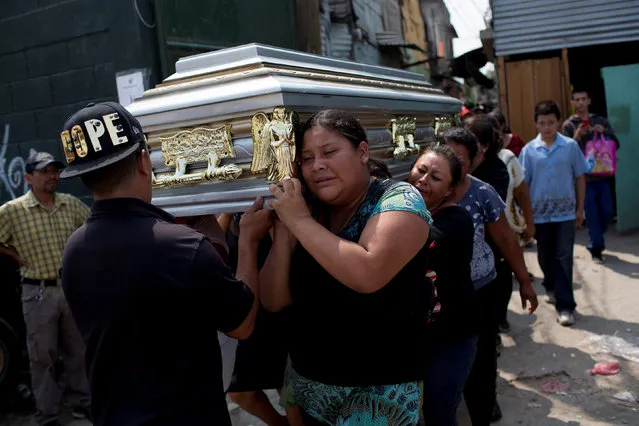 Family members and friends carry the coffin of Juana Martina Villata, a garbage collector who was killed after a massive pile of garbage collapsed and buried her at a landfill dumpsite, toward the cemetery in Guatemala City, Guatemala, April 29, 2016. (Photo by Saul Martinez/Reuters)