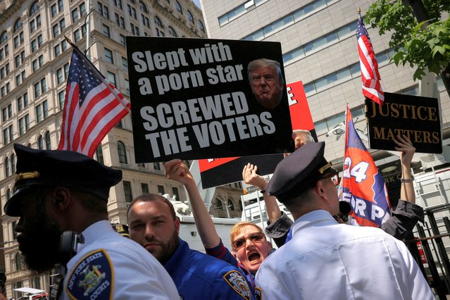 A protester yells toward a press conference by Republicans and supporters of former U.S. President Donald Trump after they attended his trial for allegedly covering up hush money payments linked to extramarital affair with Stormy Daniels, in Manhattan, New York City on May 20, 2024. (Photo by Andrew Kelly/Reuters)